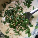 chopped parsley and sesame seeds on miso-tahini sauce